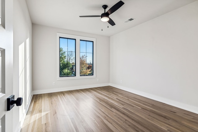 empty room with ceiling fan and light hardwood / wood-style floors