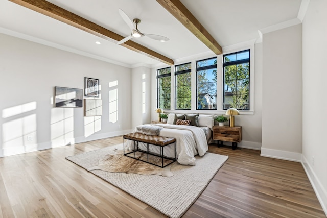 bedroom with beam ceiling, ceiling fan, ornamental molding, and hardwood / wood-style flooring