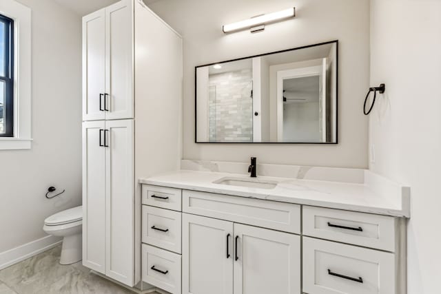 bathroom featuring vanity, toilet, and walk in shower