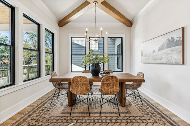 dining space featuring beamed ceiling, hardwood / wood-style floors, and a chandelier