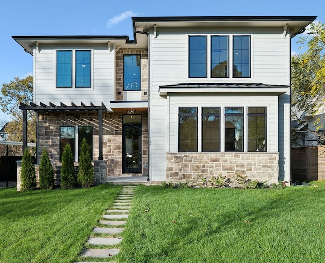 view of front of property with a pergola and a front lawn