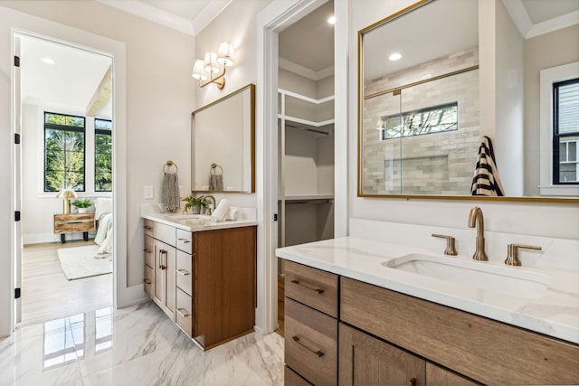 bathroom with ornamental molding, vanity, and a shower with shower door