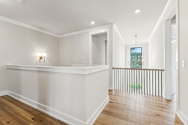 corridor featuring light hardwood / wood-style floors and ornamental molding