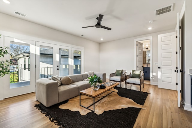 living room featuring ceiling fan and light hardwood / wood-style floors