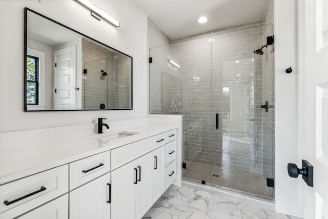 bathroom with vanity and a shower with shower door