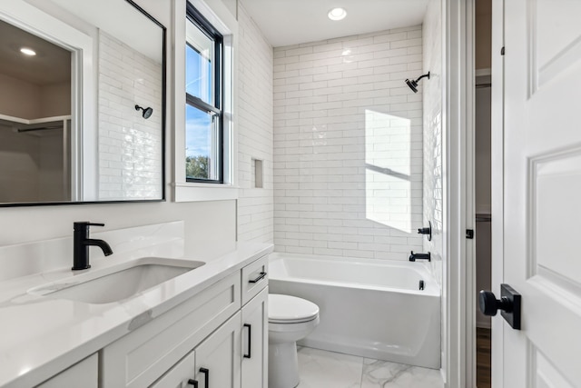 full bathroom with vanity, toilet, and tiled shower / bath