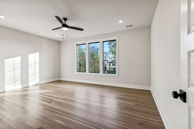 unfurnished room with hardwood / wood-style floors and ceiling fan