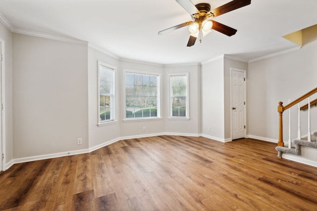 interior space featuring ceiling fan, hardwood / wood-style floors, and ornamental molding