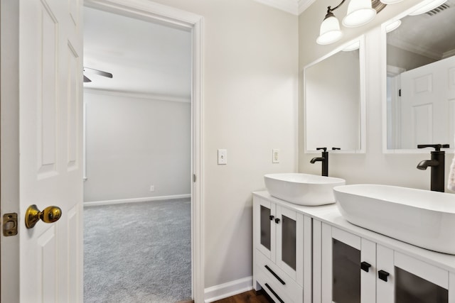 bathroom with ceiling fan, crown molding, and vanity