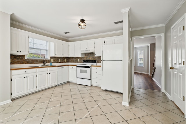 kitchen with white appliances, white cabinetry, ornamental molding, and sink