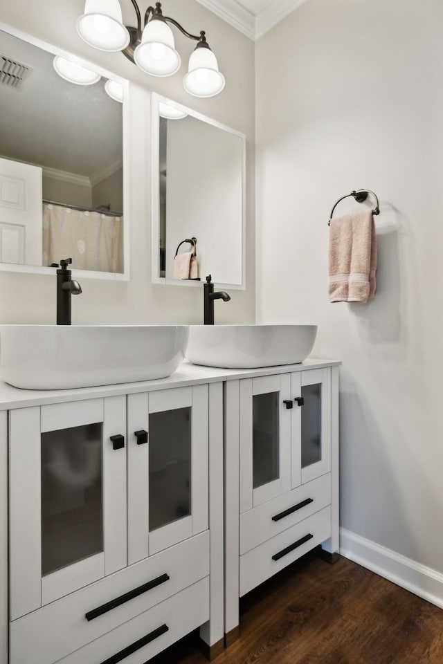 bathroom with vanity, hardwood / wood-style flooring, and ornamental molding