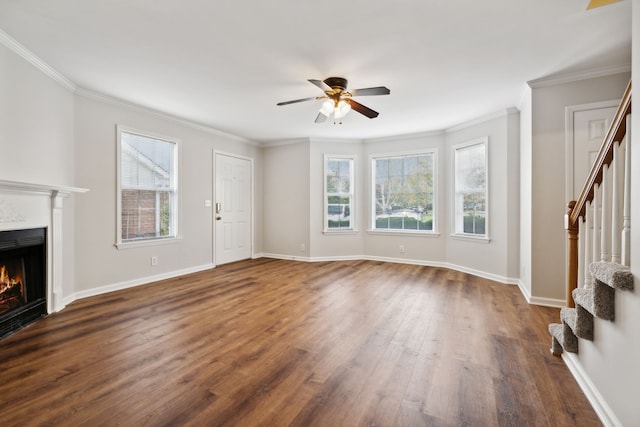 unfurnished living room featuring ceiling fan, dark hardwood / wood-style flooring, and ornamental molding