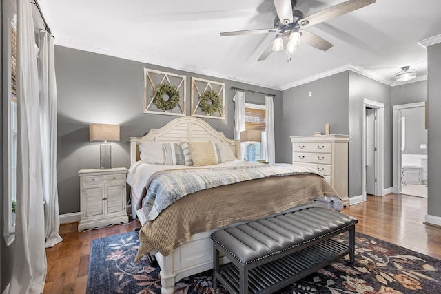 bedroom with dark hardwood / wood-style flooring, connected bathroom, ceiling fan, and ornamental molding