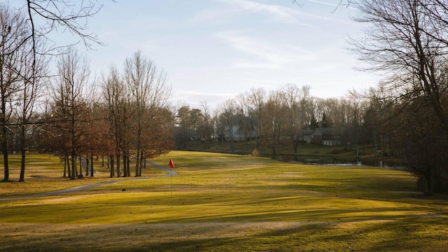 view of community with a lawn and a water view