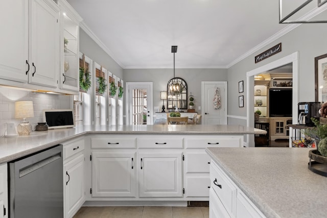 kitchen featuring decorative light fixtures, light tile patterned floors, white cabinetry, and stainless steel dishwasher