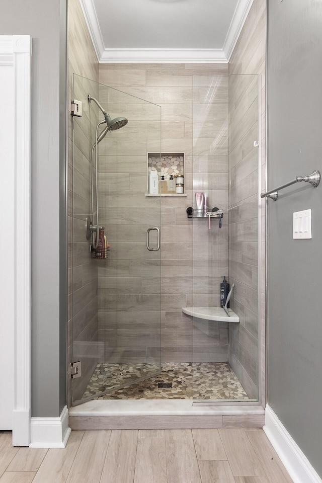 bathroom featuring an enclosed shower and crown molding