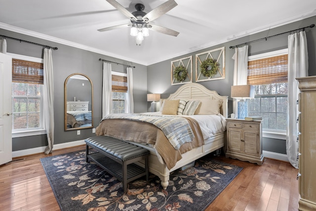 bedroom with ceiling fan, light hardwood / wood-style flooring, and crown molding