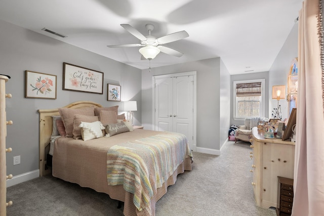 bedroom with a closet, ceiling fan, and light carpet