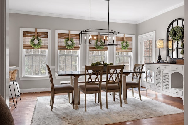 dining space featuring light hardwood / wood-style flooring and ornamental molding