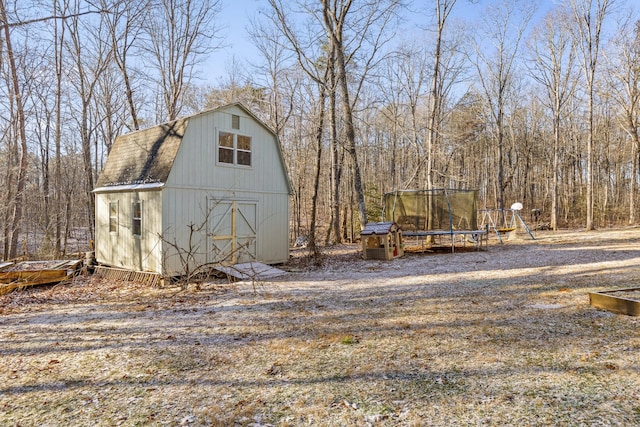 view of yard with a playground, a shed, and a trampoline