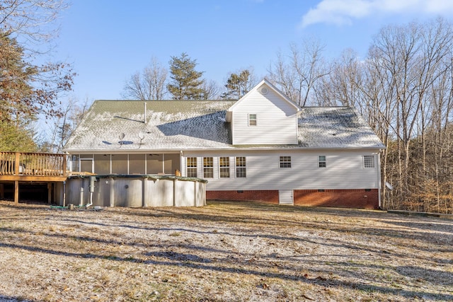 back of house with a sunroom and a deck