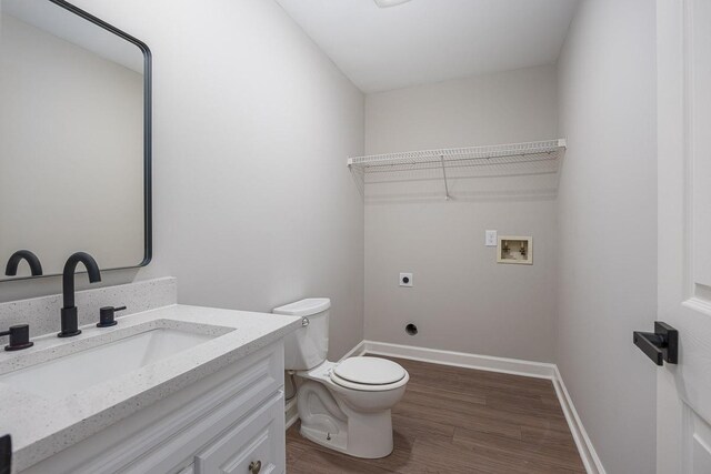 bathroom with hardwood / wood-style floors, vanity, and toilet