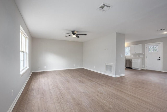 unfurnished living room featuring ceiling fan and light wood-type flooring