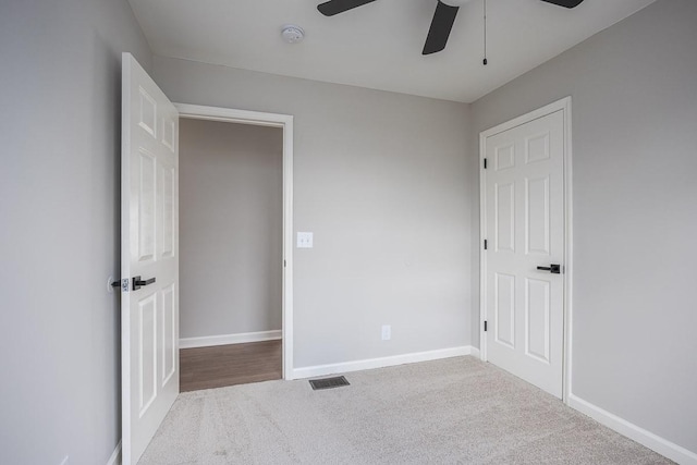 unfurnished bedroom featuring carpet and ceiling fan