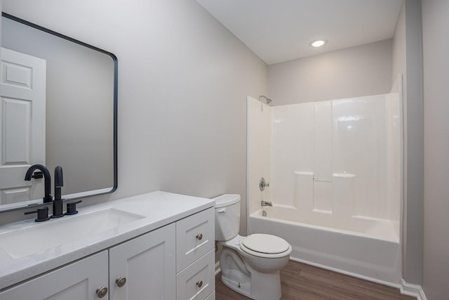 full bathroom with vanity, wood-type flooring,  shower combination, and toilet