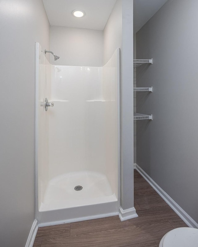 bathroom with walk in shower and hardwood / wood-style flooring