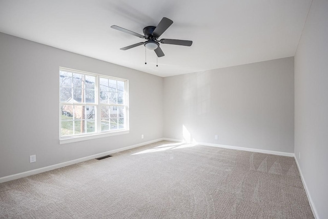 carpeted empty room featuring ceiling fan