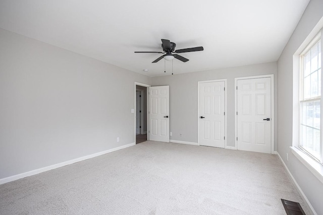 unfurnished bedroom with ceiling fan and carpet