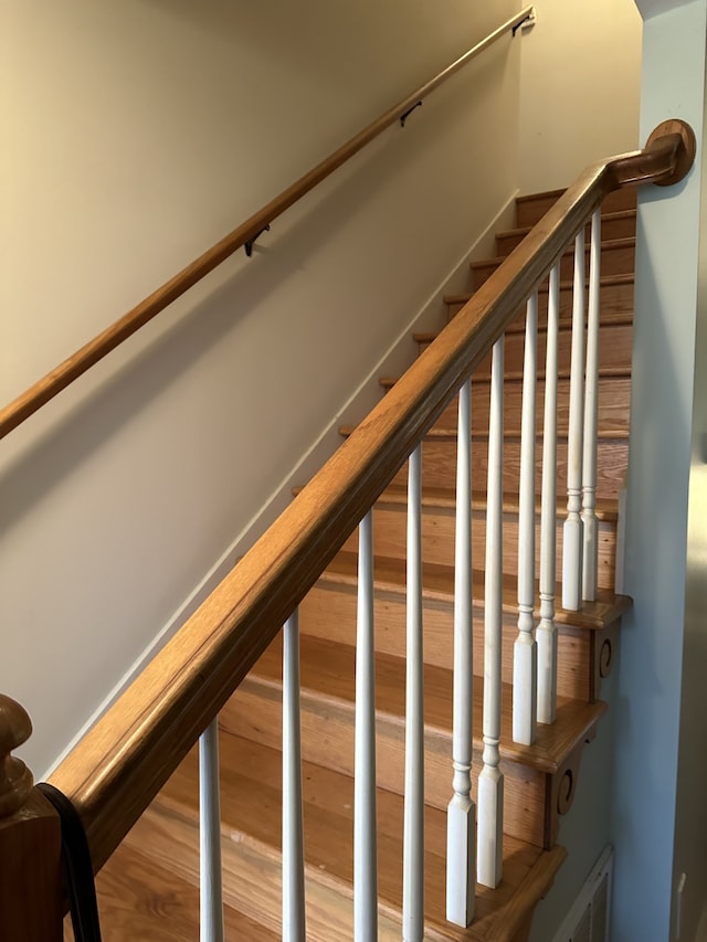 stairs featuring wood-type flooring