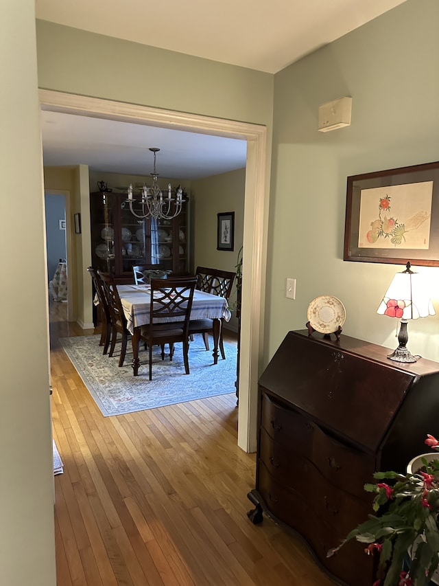 dining area featuring an inviting chandelier and hardwood / wood-style flooring