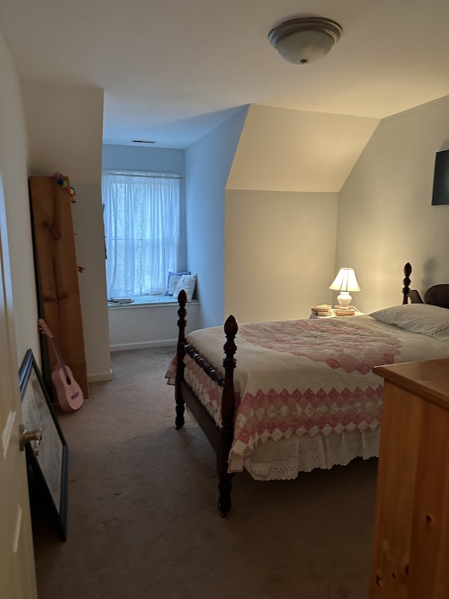 bedroom with carpet and lofted ceiling