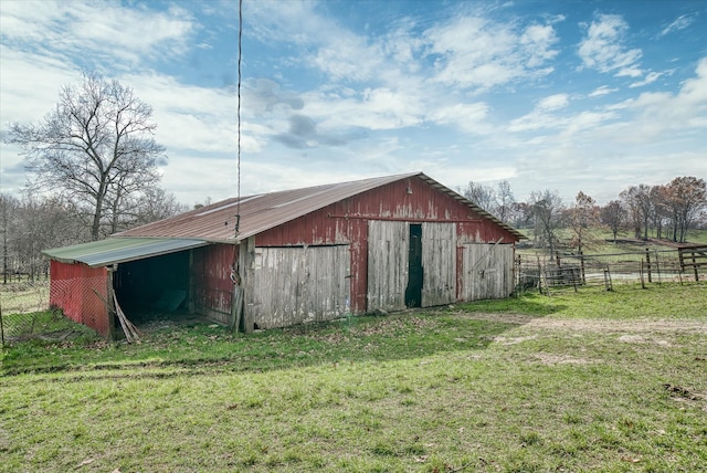 view of outdoor structure with a yard and a rural view