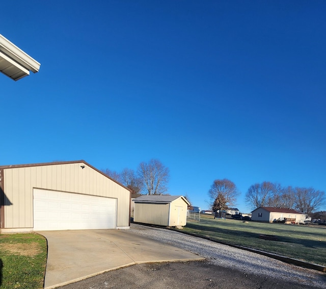 view of front facade with a garage, a shed, and a front yard