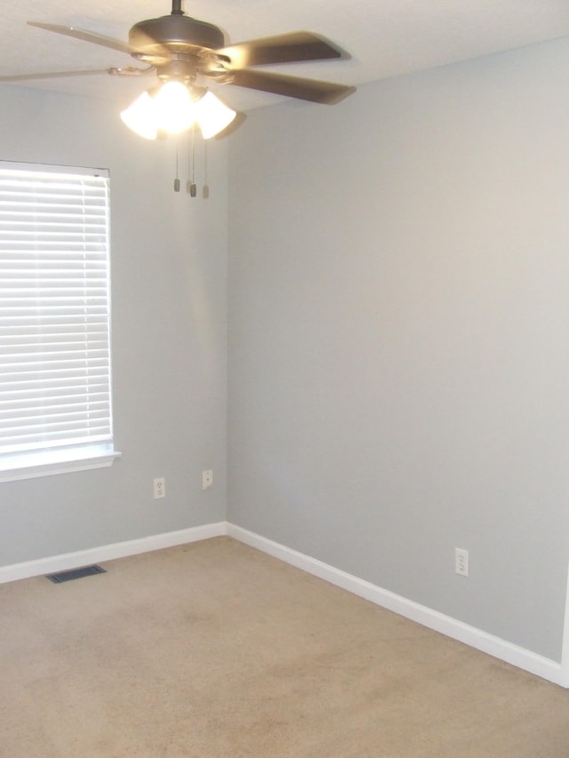 unfurnished room with carpet and ceiling fan