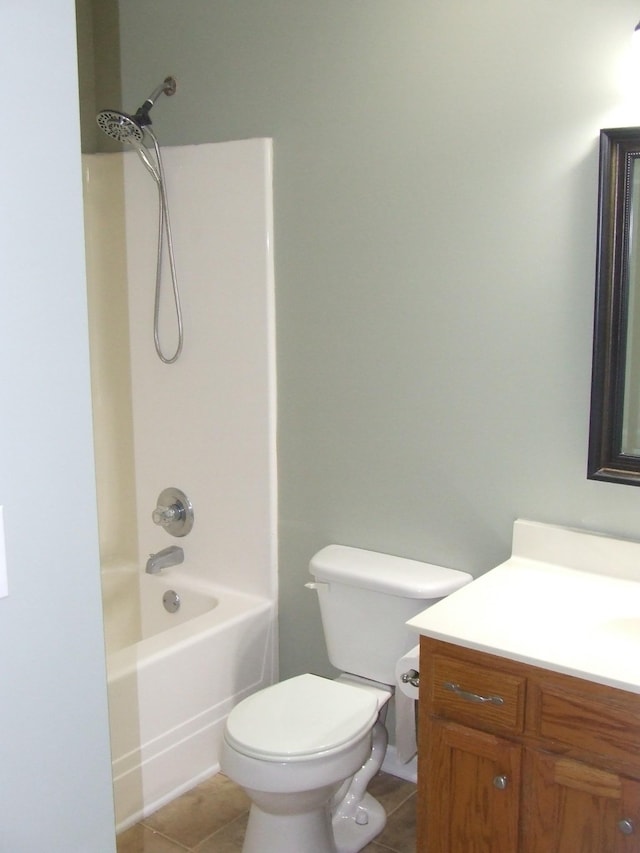 full bathroom featuring washtub / shower combination, vanity, toilet, and tile patterned flooring