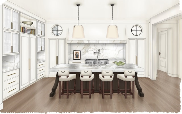 kitchen with a kitchen bar, a center island with sink, hanging light fixtures, and dark hardwood / wood-style floors