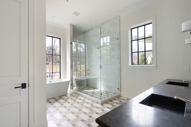 full bath featuring a wealth of natural light, a soaking tub, and a shower stall