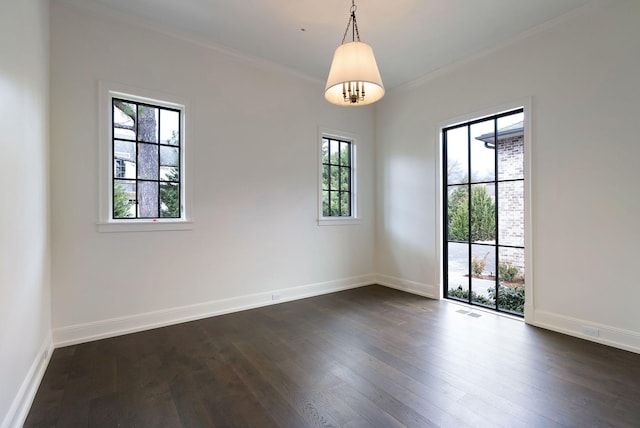 spare room with visible vents, baseboards, dark wood-style flooring, and crown molding