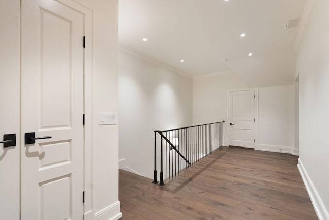 hall featuring baseboards, ornamental molding, an upstairs landing, recessed lighting, and wood finished floors