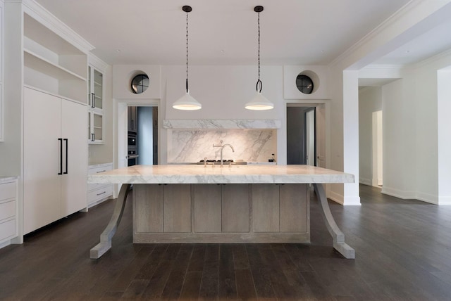 kitchen with a sink, glass insert cabinets, white cabinets, and dark wood finished floors