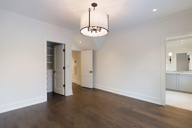 spare room featuring recessed lighting, baseboards, dark wood-type flooring, and crown molding