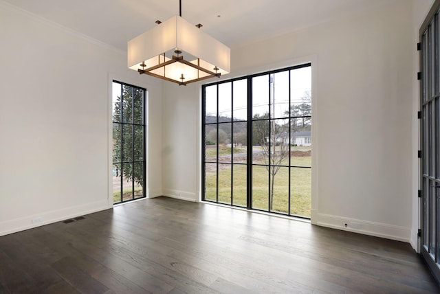 unfurnished dining area featuring baseboards, dark wood-style floors, visible vents, and a healthy amount of sunlight