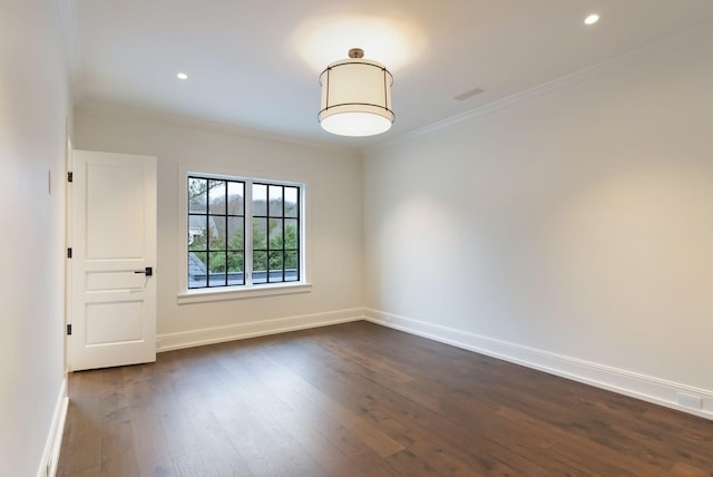 empty room featuring recessed lighting, baseboards, dark wood finished floors, and crown molding