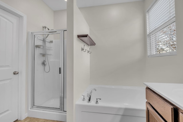 bathroom with shower with separate bathtub and vanity