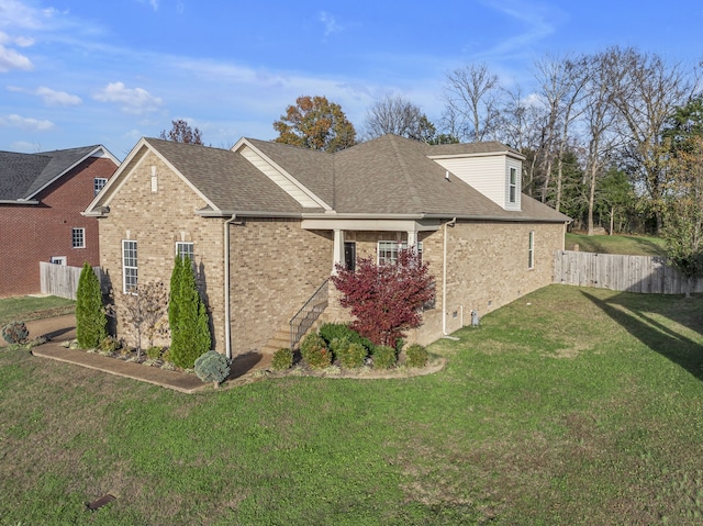 view of side of home featuring a lawn