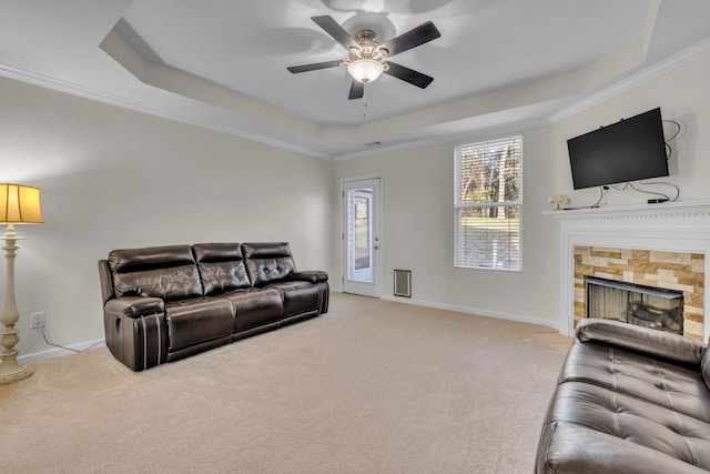 living room featuring light carpet, a tray ceiling, and crown molding